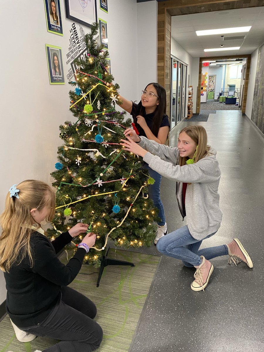 7th grade adding crocheted, ornaments, and decorations to our holiday tree. #ourBMSA #OAISS