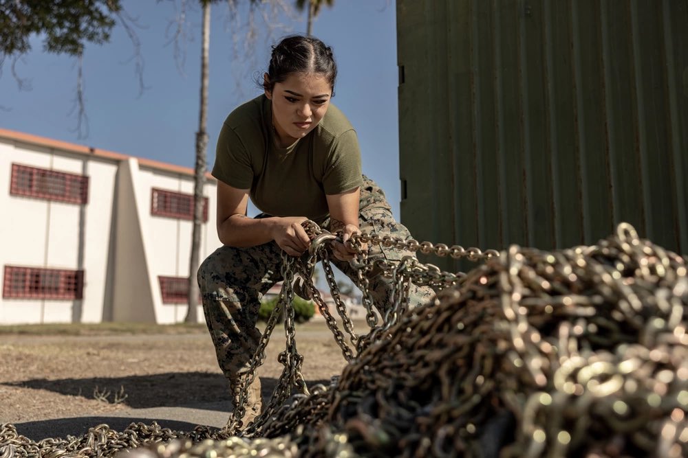 Deployment rewind U.S. Marine Corps Lance Cpl. Celeste FloresCastillo, a logistics specialist with Marine Rotational Force-Southeast Asia, I Marine Expeditionary Force, untangles chains before preparing a container for MRF-SEA's deployment on Marine Corps Base Camp Pendleton.