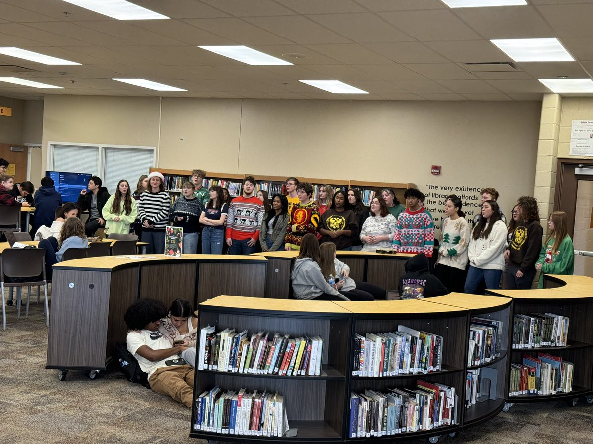 Students sing in JHS library.