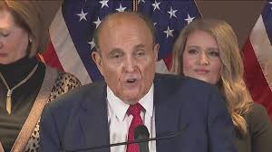 So it looks like Rudy Giuliani, the cousin marrying, butt dialing, parking lot presser next to a dildo store holding, lie down on a hotel bed for Borat’s fake daughter shirt “tucking”, airport restaurant shaving, hair dye leaking, Covid via fart spreading, trumpy pardons for $2…