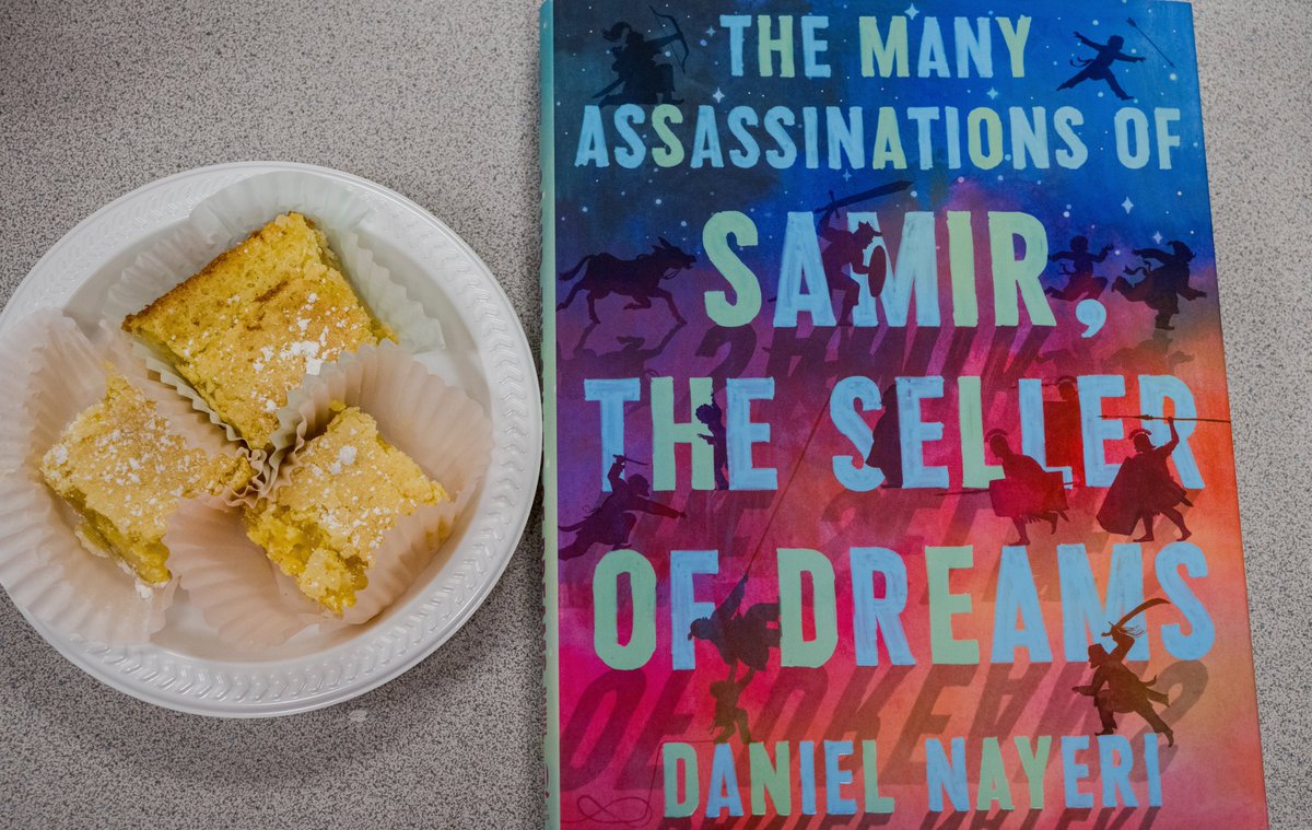 A #book AND #lemonbars from Sandra!! 'The Many Assassinations of Samir, The Seller of Dreams' by @DanielNayeri - russosbooks.com/book/978164614… #bakersfield #indiebookstore @LevineQuerido #eatsleepread #fortheloveofbooks #bookwormwithacamera #snacknapread