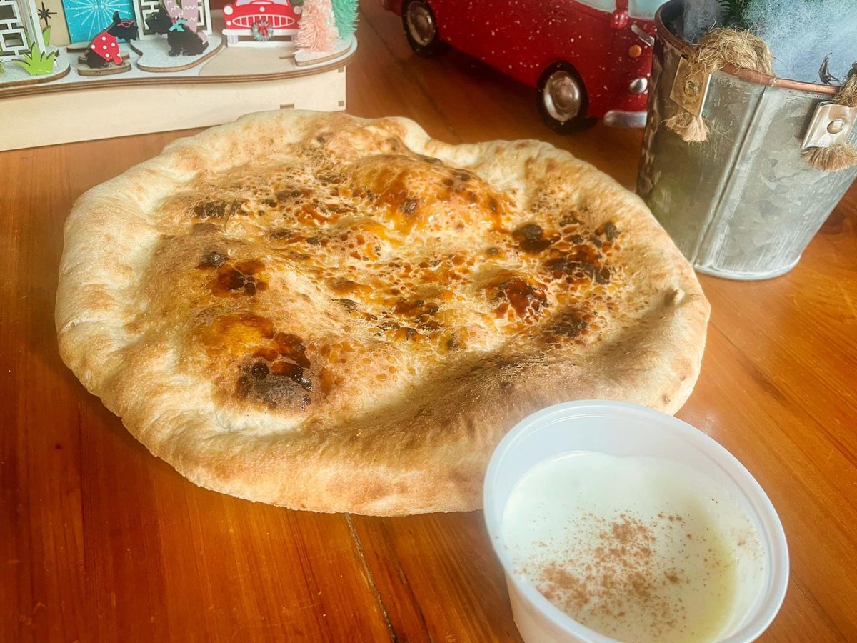 Gingerbread Brûlée Pizza - a Neapolitan dough with gingerbread spices, topped with raw sugar that brûlées in our wood-fired oven.  Served with a side of icing for dipping, this is one of the Nice pizzas on our Naughty or Nice Christmas Menu.  #naughtyornice #LA31 #pizzatoday