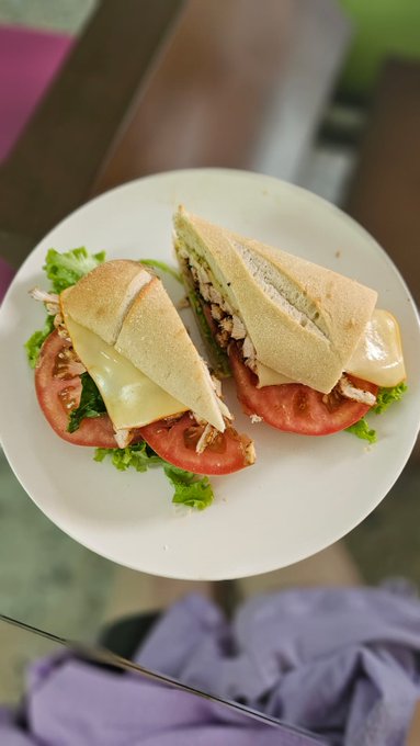 Grilled cajun style  chicken breast with arugula, pesto, heirloom tomatoes and meunster cheese on fresh