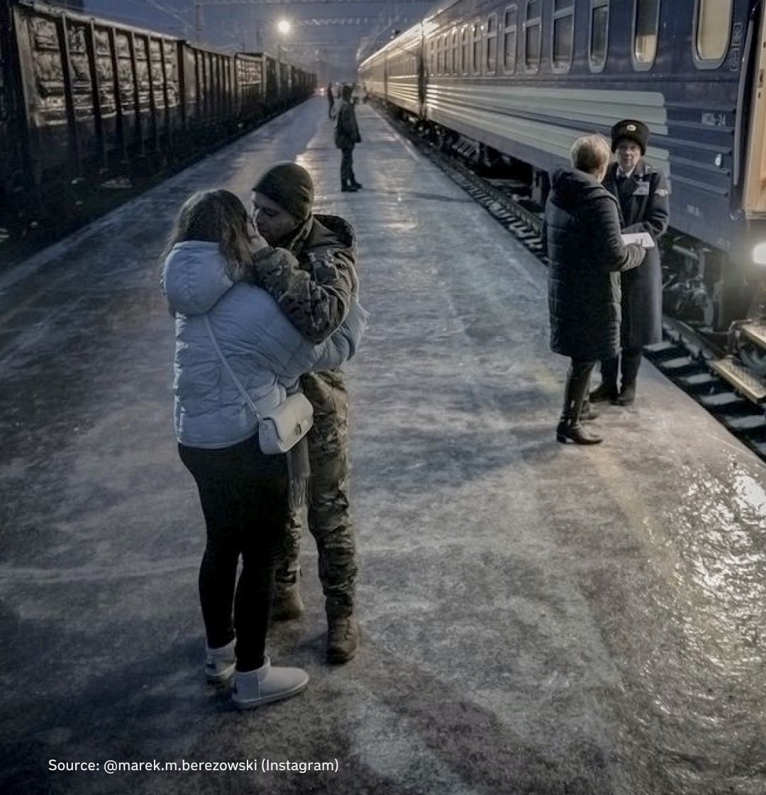 A couple embrace at a provincial railway station. Wartime Ukraine, winter 2023