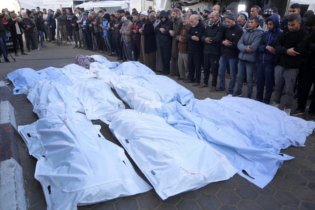 Relatives of the Palestinians died in Israeli attacks, mourn as they receive the dead bodies from the morgue of Al-Aqsa Martyrs Hospital for a funeral ceremony while the Israeli attacks continue in Deir Al Balah, Gaza on December 18, 2023. Photo by Ashraf Amra