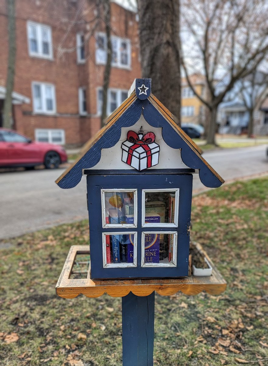 A seasonal update to the little free library's little stained glass.