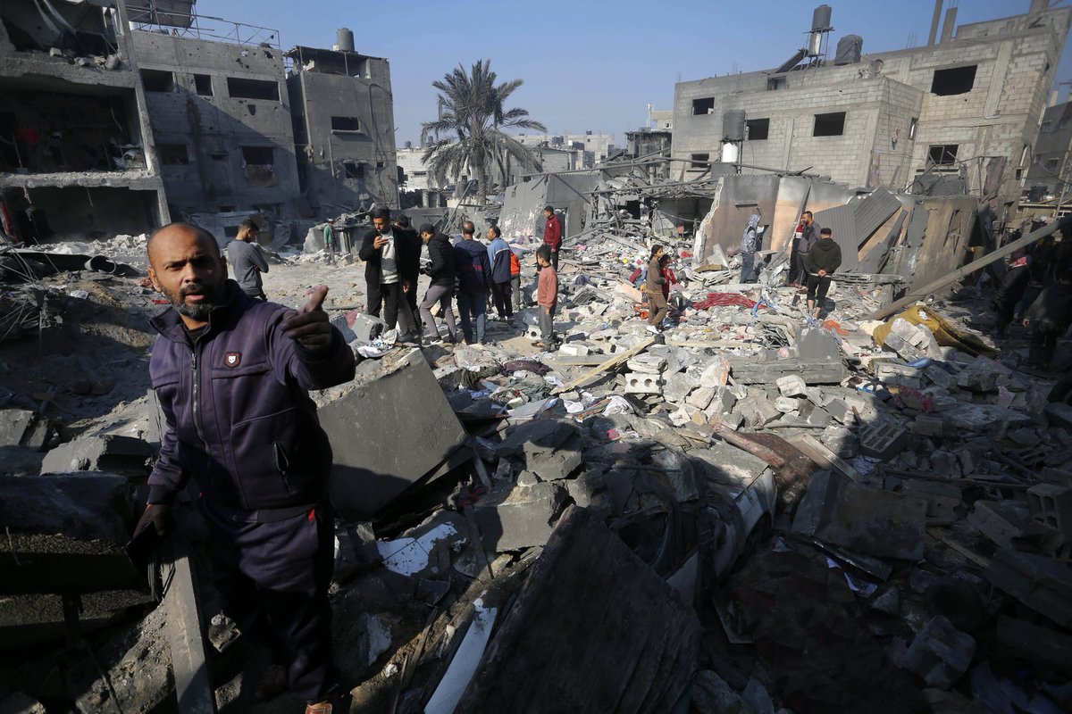 Residents and civil defense teams conduct search and rescue operation around the rubble of the building following an Israeli attack on house belonging to Kistan family at the Nuseirat refugee camp in Deir al-Balah, Gaza on December 18, 2023. Photo by Ashraf Amra
