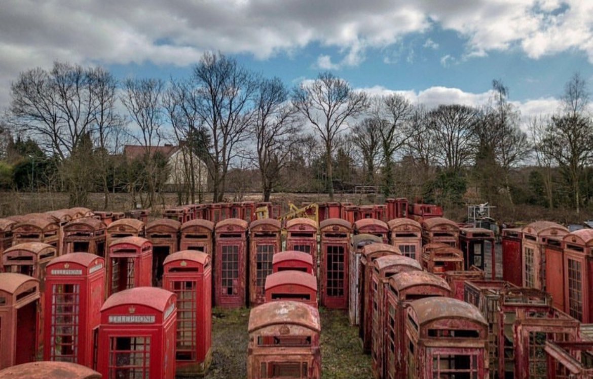 The Red Telephone Box Cemetery in Carlton Miniott, a small village in North Yorkshire, England, is a unique and nostalgic location that showcases the history of public telephone boxes in the United Kingdom. Designed by Sir Giles Gilbert Scott, these iconic red telephone boxes