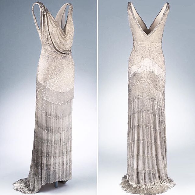 Day 19 of my Christmas #AdventCalendar is a c. 1931 House of Worth silk tulle evening dress, densely embroidered with silver glass bugle beads that extend into deep layers of fringe and are worked into intricate braids at the shoulders. @metmuseum collection #1930sfashion