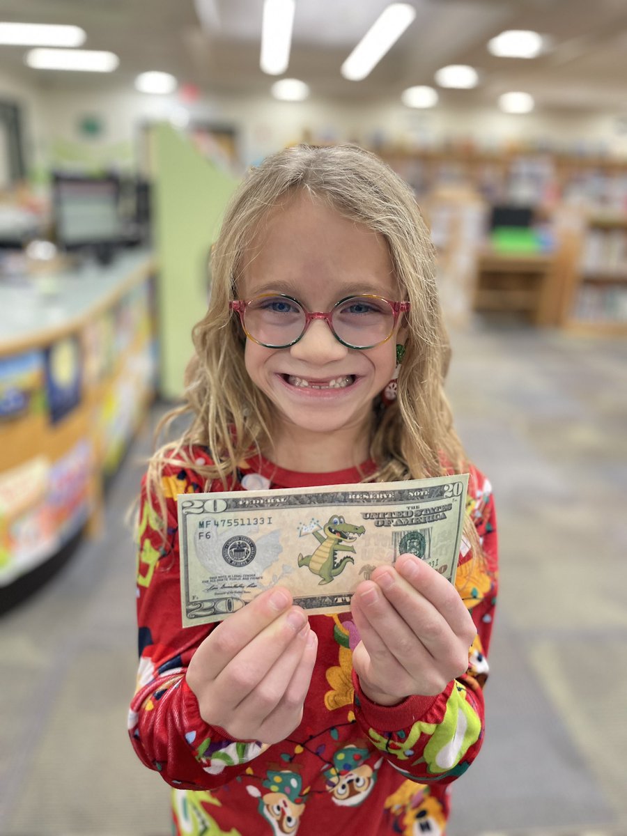 This is one proud gator! She is so excited to shop with her “book bucks”! #lcelower #ReadingRocks