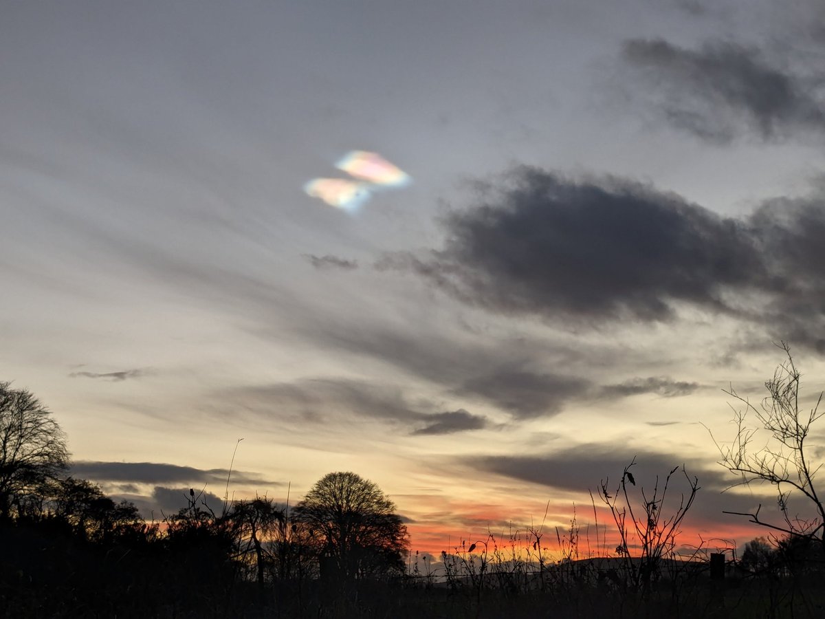 What a cool sight this evening!! I've now learned that they are nacreous clouds which have smaller ice particles than normal and reflect light differently creating an effect I couldn't quite capture on my phone below...