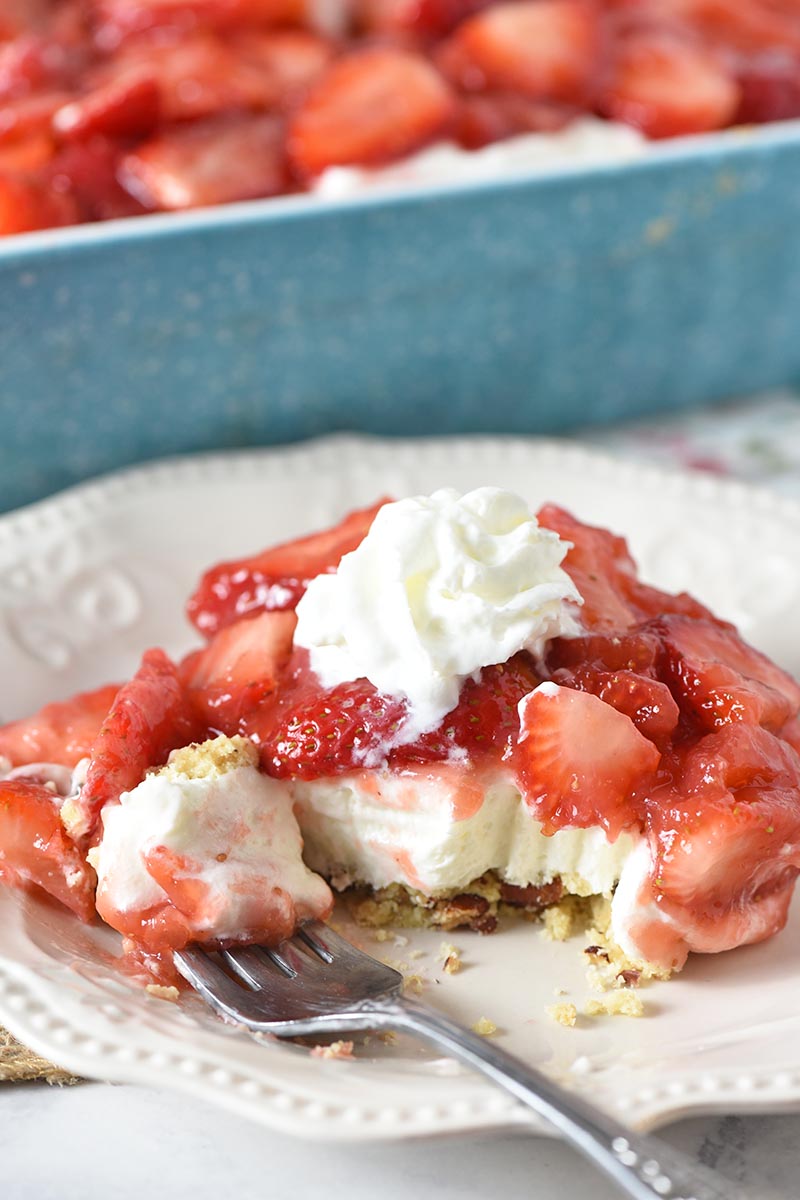 Make an easy strawberry yum yum dessert layered with fresh strawberries, a no bake cream cheese filling, and pecan crust. This dreamy strawberry delight is perfect for potlucks and gatherings! adventuresofmel.com/strawberry-del…