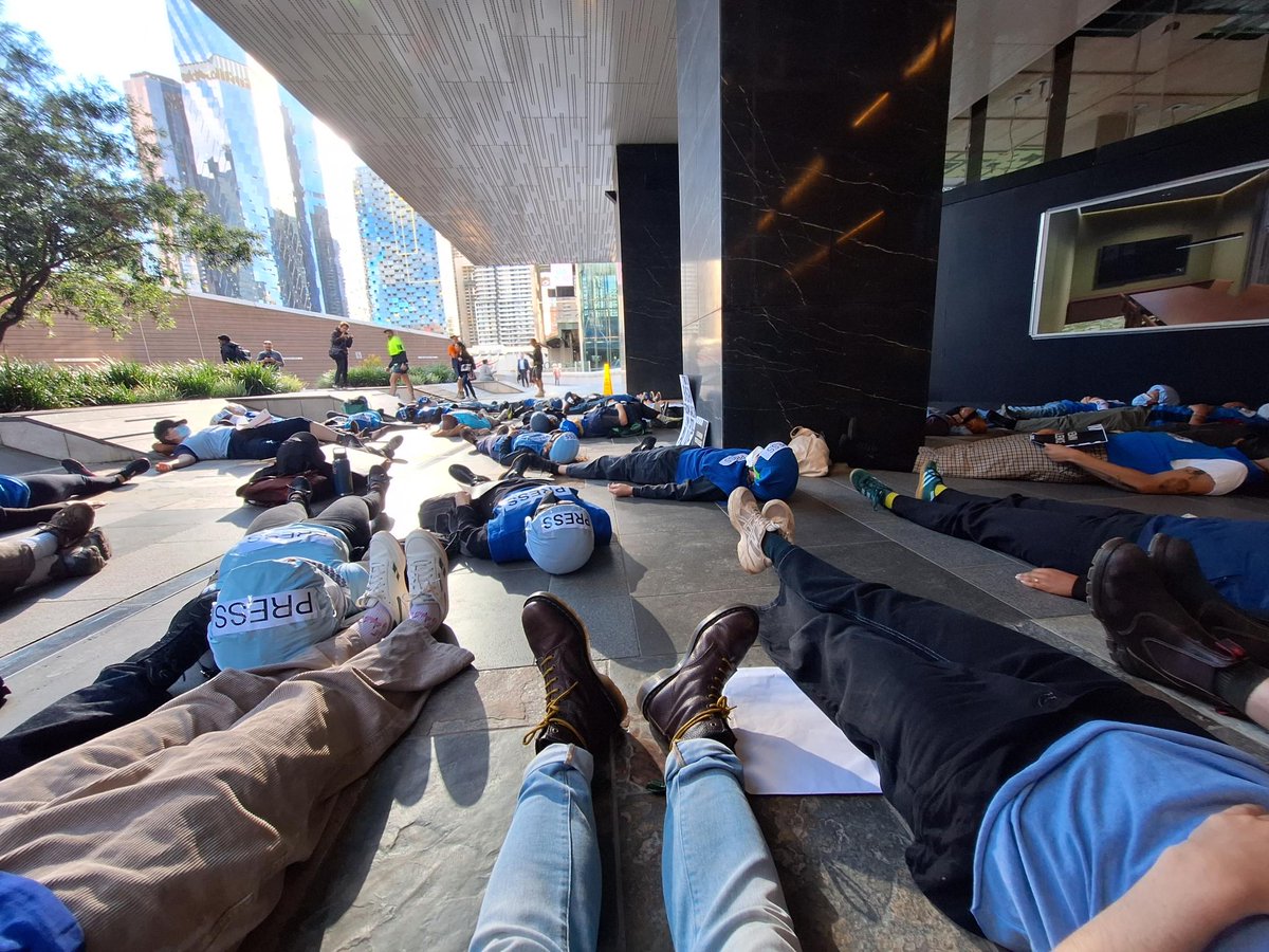 BREAKING Wednesday 20 December 2023 Activists block entrance of The Age headquarters dressed in press vests and helmets to protest the Australian media silence on journalist deaths in Gaza