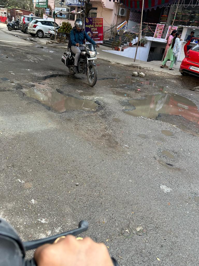 poojadapa's tweet photo. Probably the worst road in Hyderabad with massive potholes, giving hard time to riders. What is the Govt doing with the road taxes ? @revanth_anumula @GadwalvijayaTRS @CommissionrGHMC @hydcitypolice @narendramodi https://t.co/97ymufJJfg