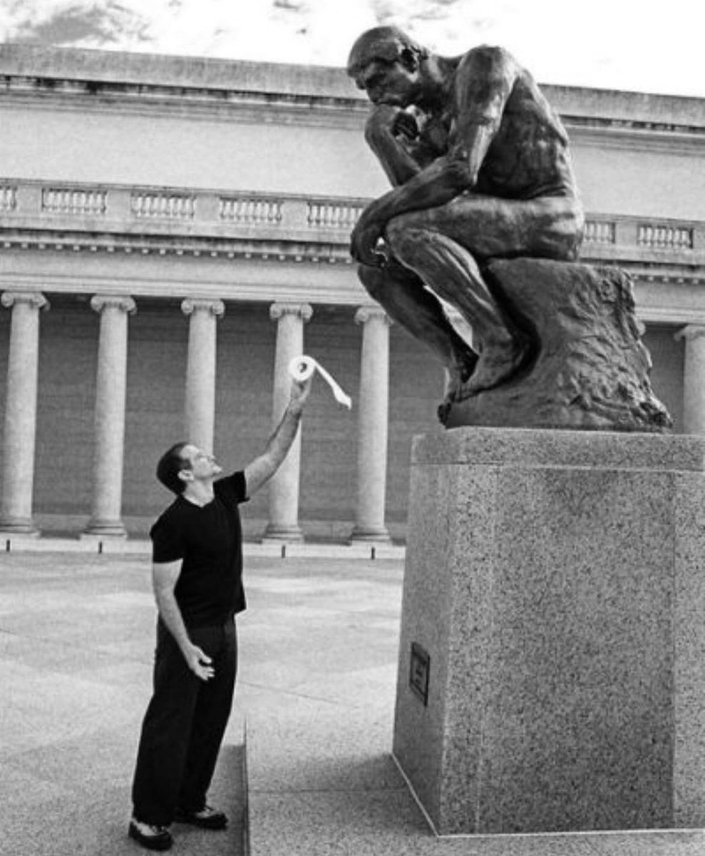 Robin Williams offers Auguste Rodin's 'The Thinker' a roll of toilet paper.