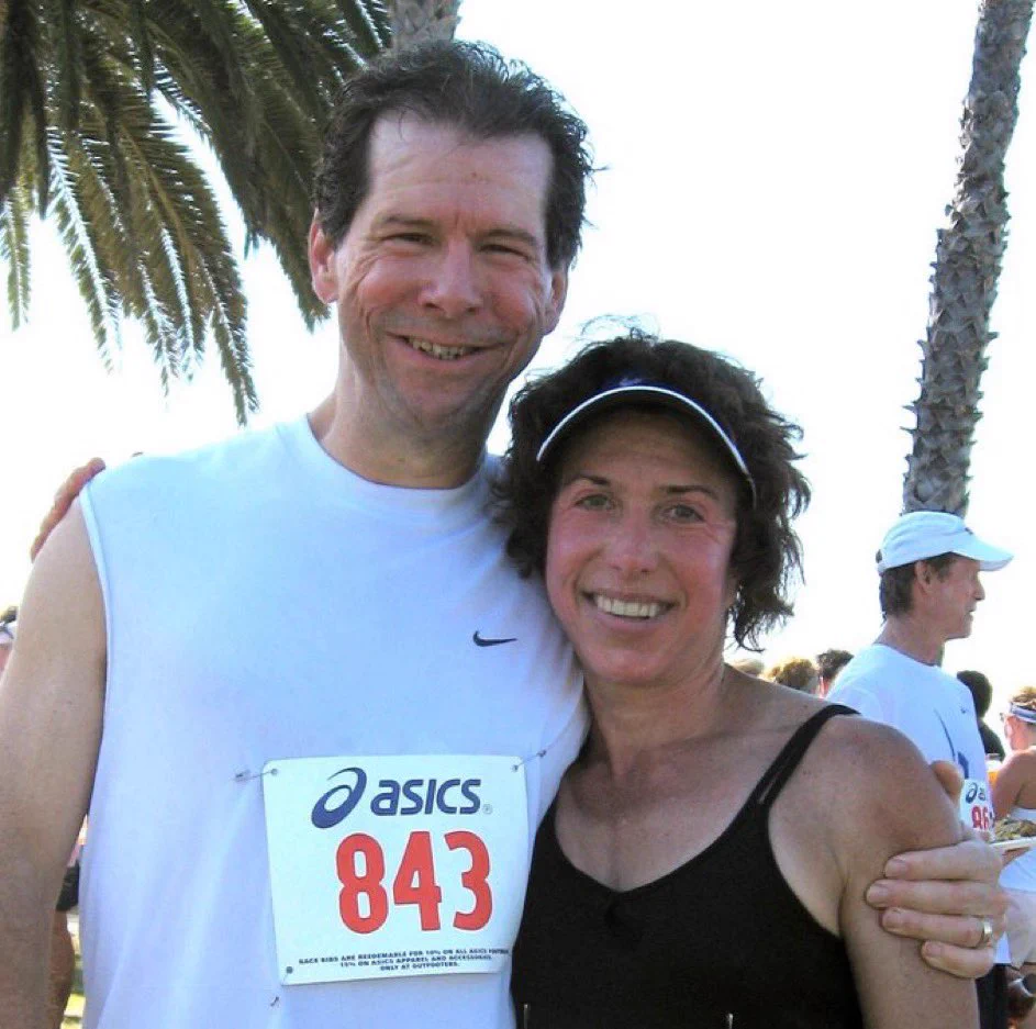 Hal and Fran Finney stand together at a running event.