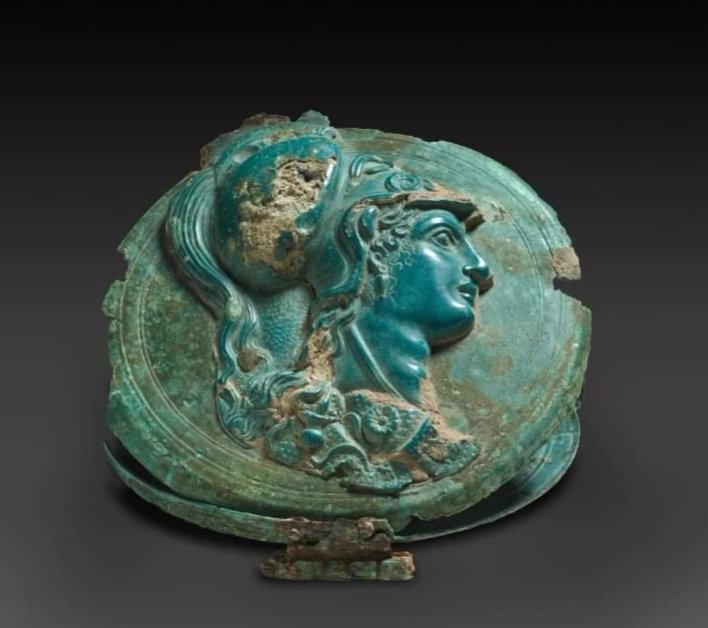 histories_arch's tweet photo. Greek Bronze Box Mirror with Head of Athena (330–270 BC) :

The ancient Greek box mirror resembles a modern, hinged makeup compact in design. While the actual mirror is the top of the bottom half of the box, a highly polished cast-bronze disk the cover often bears relief decoration. This example features a helmeted head of Athena, a virgin war goddess not typically associated with implements of beauty. Several other aspects suggest that this Athena may have been repurposed from another object in antiquity: the striking difference in patina between relief and case; the irregular (noncircular) shape; and the method of attachment, with rivets through the relief rather than solder.

(4 7/16 in.)

Cleveland Museum of Art

#archaeohistories