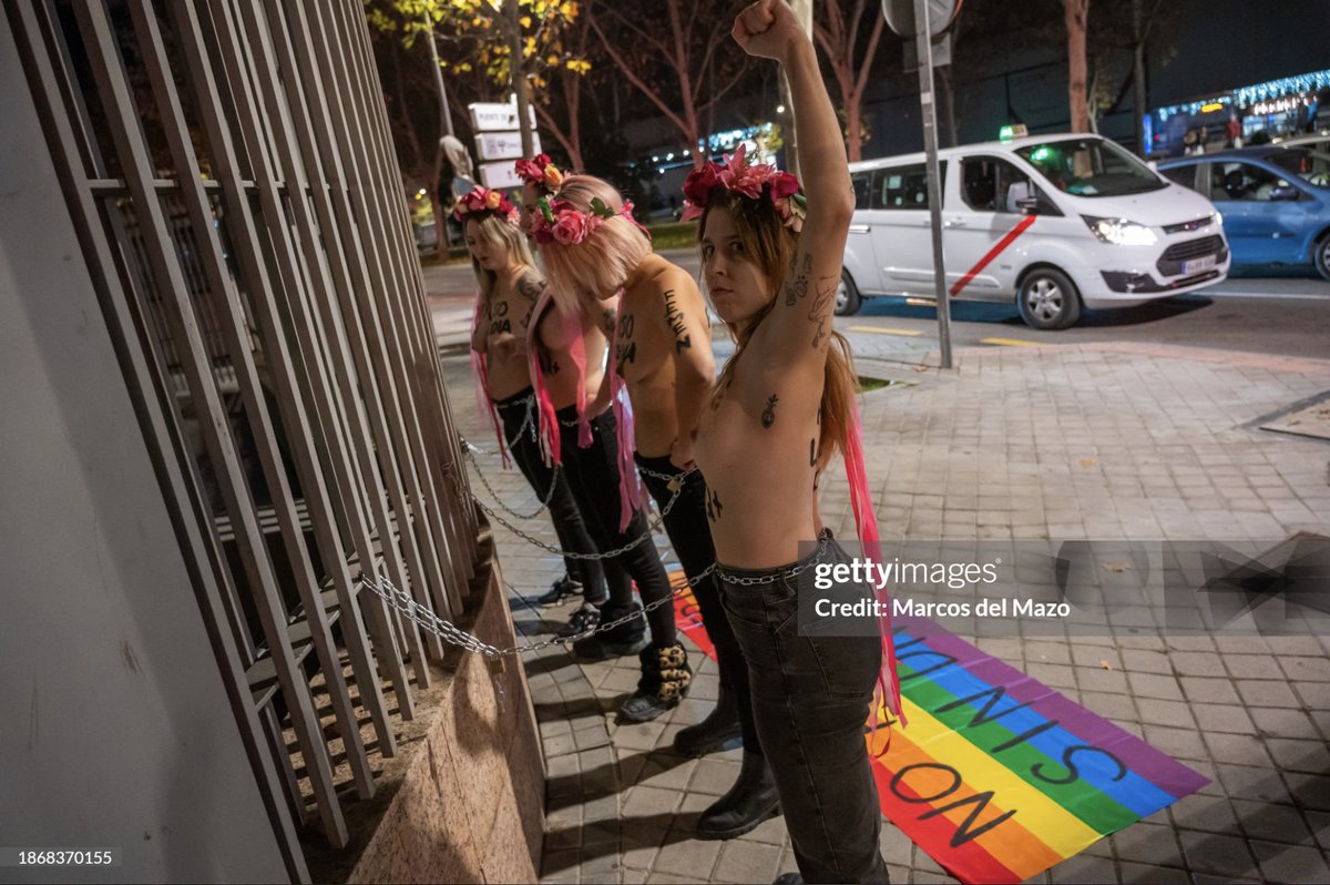 Activists of @FemenSpain protest chained to a fence of the Assembly of #Madrid demanding rights for the #LGBTQ