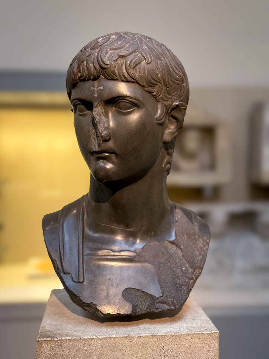 This green basanite bust of the Roman general-politician Germanicus Caesar was mutilated in antiquity, almost certainly by Christians. His nose has been hacked off, his chest gouged, and a cross has been cut into his forehead. From Egypt, ca. 14-20 CE. #BritishMuseum 📸my own