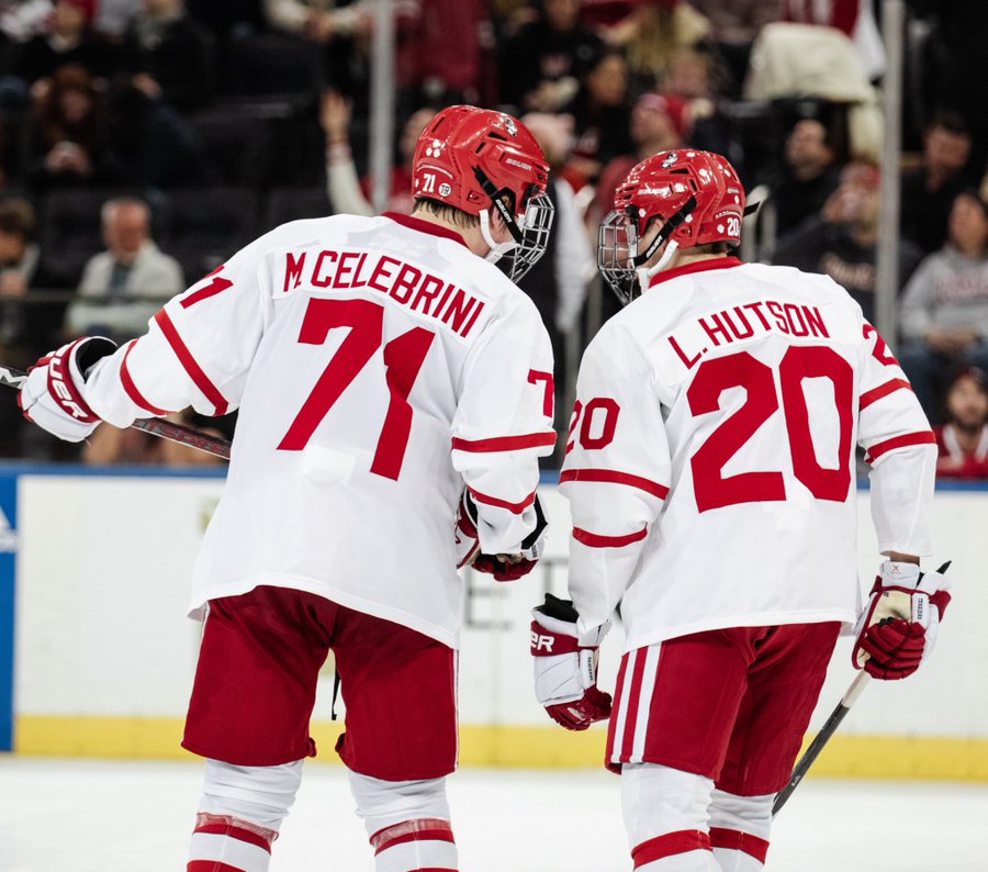 Macklin Celebrini talking to Lane Hutson on the ice during Red Hot Hockey.