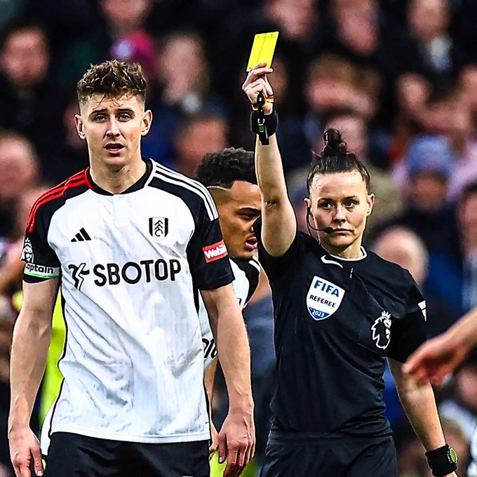 Rebecca Welch showing yellow card to Tom Cairney