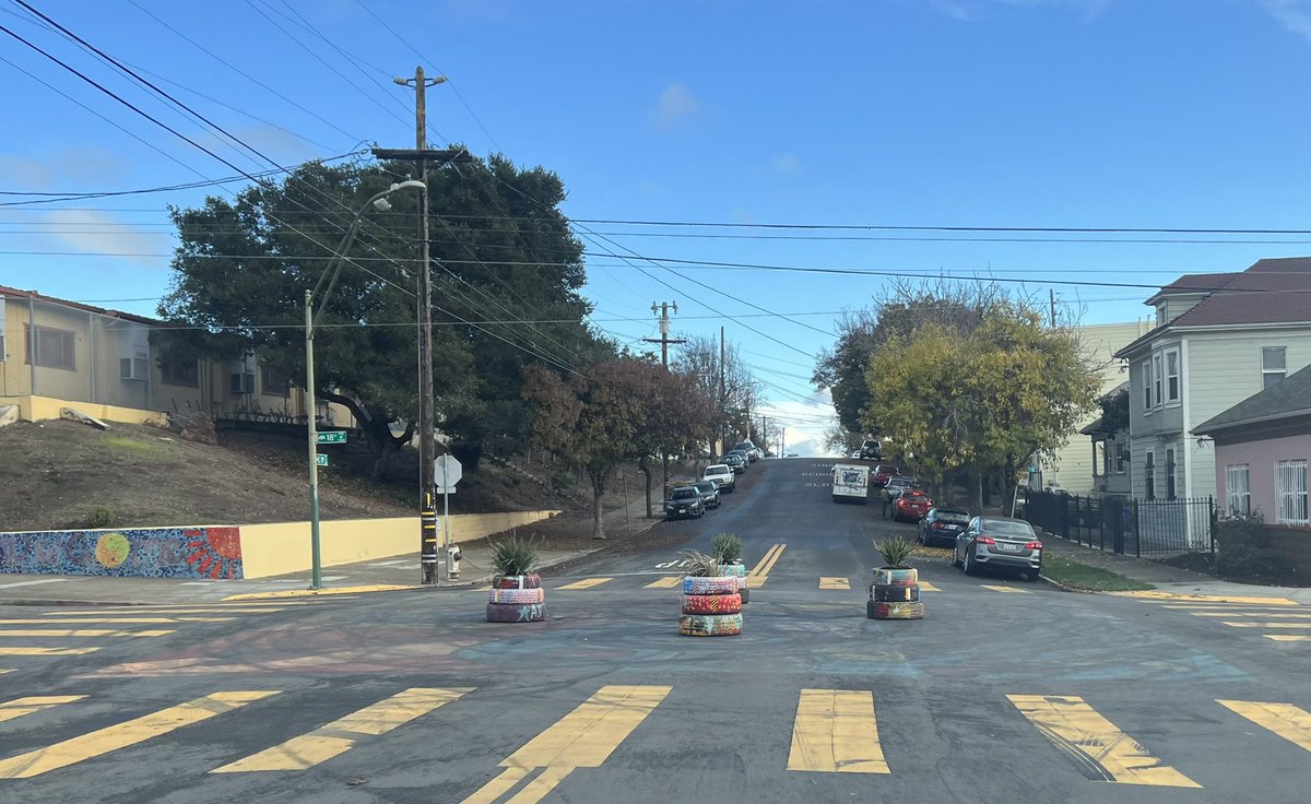 Victory4Oakland's tweet photo. Traffic calming at intersection of 18th and E.19th which is between San Antonio Park and Roosevelt Middle School. You can see all the skid marks from donuts and people would often blow through stop signs. Great to see this improvement.
#VictoryforOakland #Oakland #eastOakland https://t.co/CFIXXBCFrT