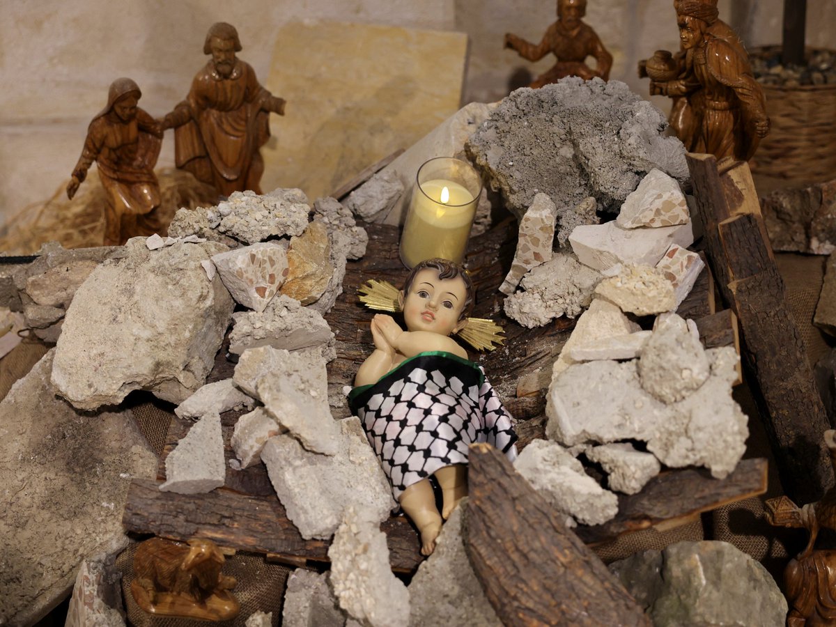 The #NativityScene scene in Manger Square, #Bethlehem, this year, has the Baby Jesus cradled in rubble and wearing a Palestinian kefiya.

Arab Christian solidarity with the people of Gaza gives the lie to the ridiculous propaganda of Christian-Zionists & Israel apologists.