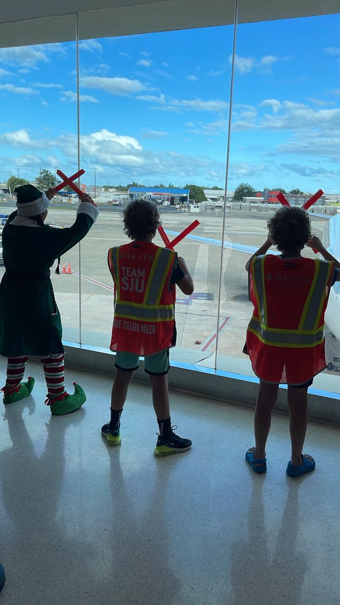 HolzbauerMark's tweet photo. On our way back from a fantastic trip to Puerto Rico.  @Delta made gave the boys a little Christmas gift.  Helped guide a plane in with one of Santa’s helpers and toured the cockpit. #SJU #Delta https://t.co/fDKKwYcymU