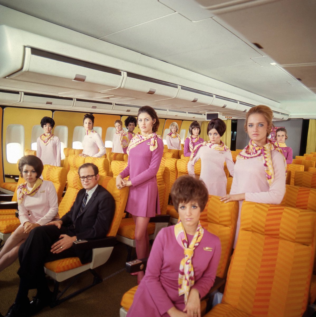 flight attendant uniforms designed by prestigious fashion designers — a thread