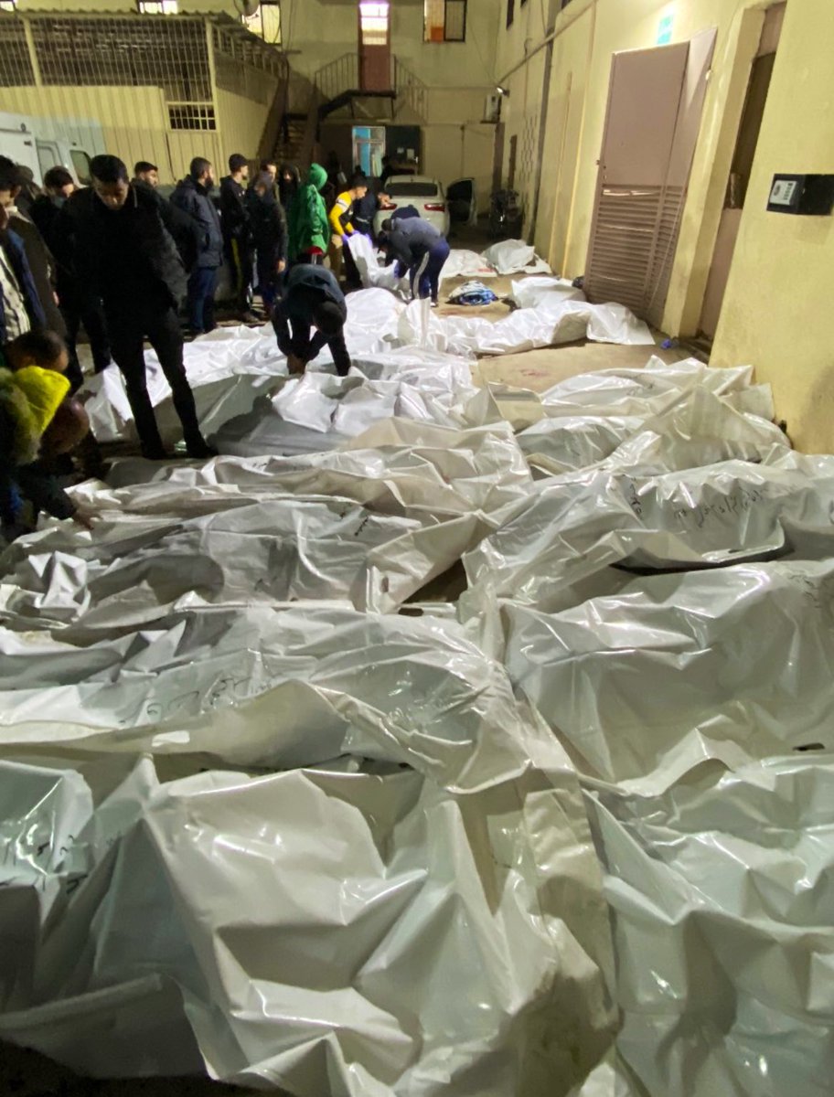 falasteen47's tweet photo. BREAKING: Israel commits a Christmas Eve massacre, murdering over 80 civilians in one strike.

Body parts of men, women, children &amp; babies scattered everywhere in Maghazi refugee camp.

#Gaza_Genocide https://t.co/iPqSBRzReR