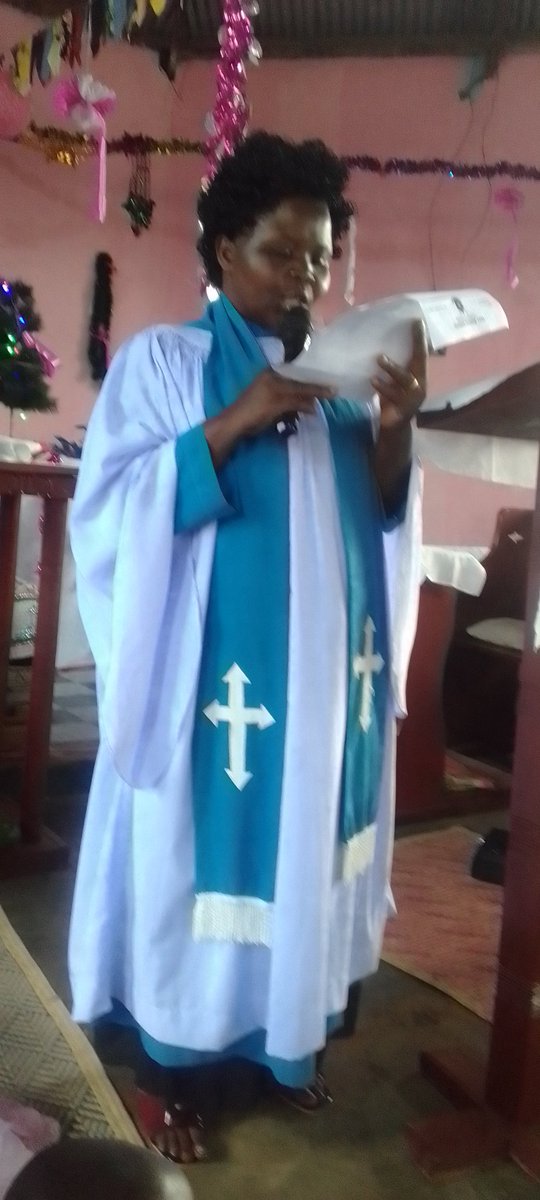 The lay reader Harriet Kagoma of St Luke's church Nankoma reading Christmas message from the Bishop of East Busoga Diocese Rt Paul Hannington Ssuubi.