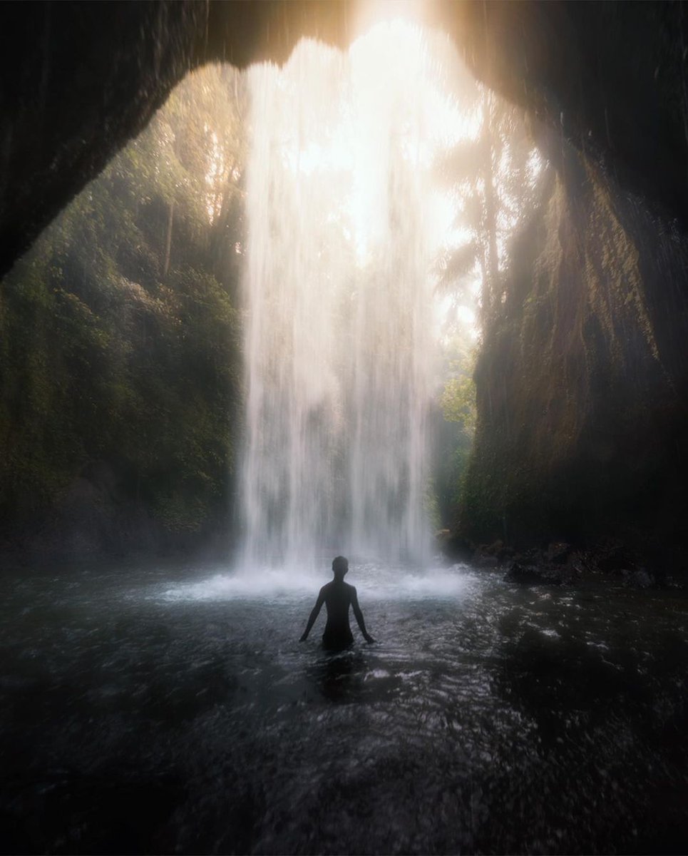 Wade behind a waterfall's curtain, where the roaring sound transforms into a strangely serene symphony. Nature's music at its best! 🌊🌿 #WonderfulJourney #WonderfulIndonesia #WaterfallSerenade #NatureSounds #TranquilMoments 
📷 credit: @felgrafelgra