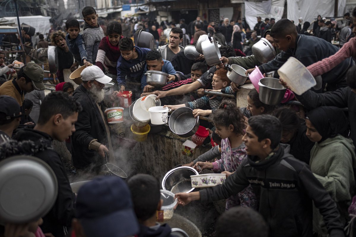 Palestinians line up for a free meal in Rafah, Gaza Strip. International aid agencies say Gaza is suffering from shortages of food, medicine and other basic supplies as a result of the two and a half month war between Israel and Hamas. (AP Photo/Fatima Shbair) @AP