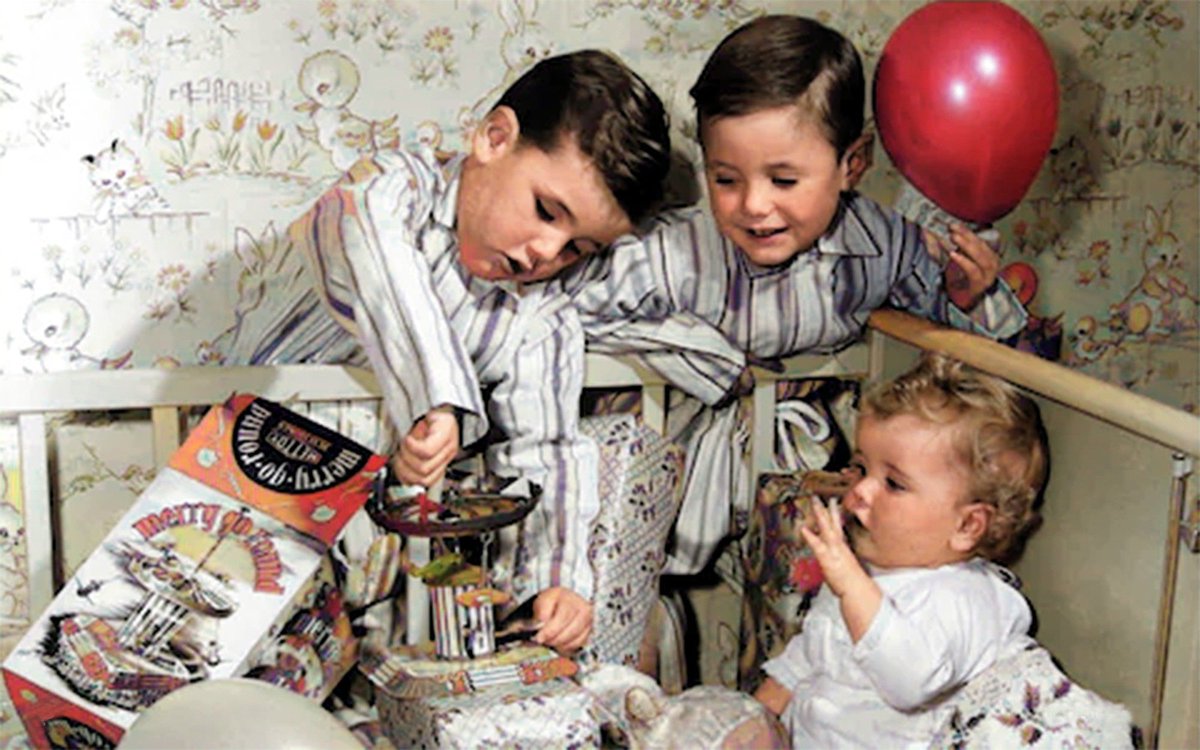 Children unwrapping their presents on Christmas morning in 1950. #christmasday #the50s #thefifties #christmaspresents #colourised