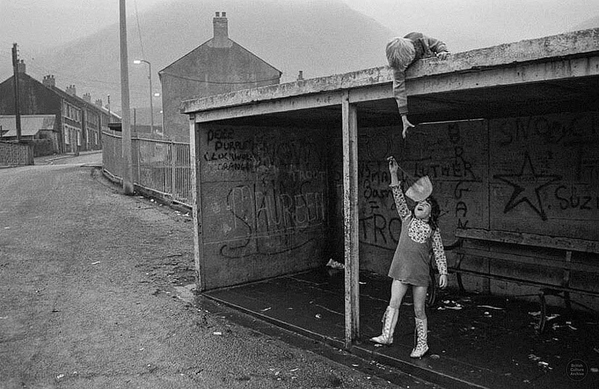 Children play at a bus stop in Blaencwm, near Treherbert in the Rhondda Fawr Valley, South Wales, 1973. Photo © Robin Weaver, all rights reserved.