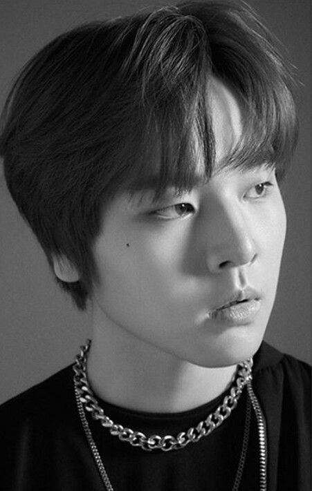 bold vibes with a pixie cut and a killer necklace embracing the monochrome magic.