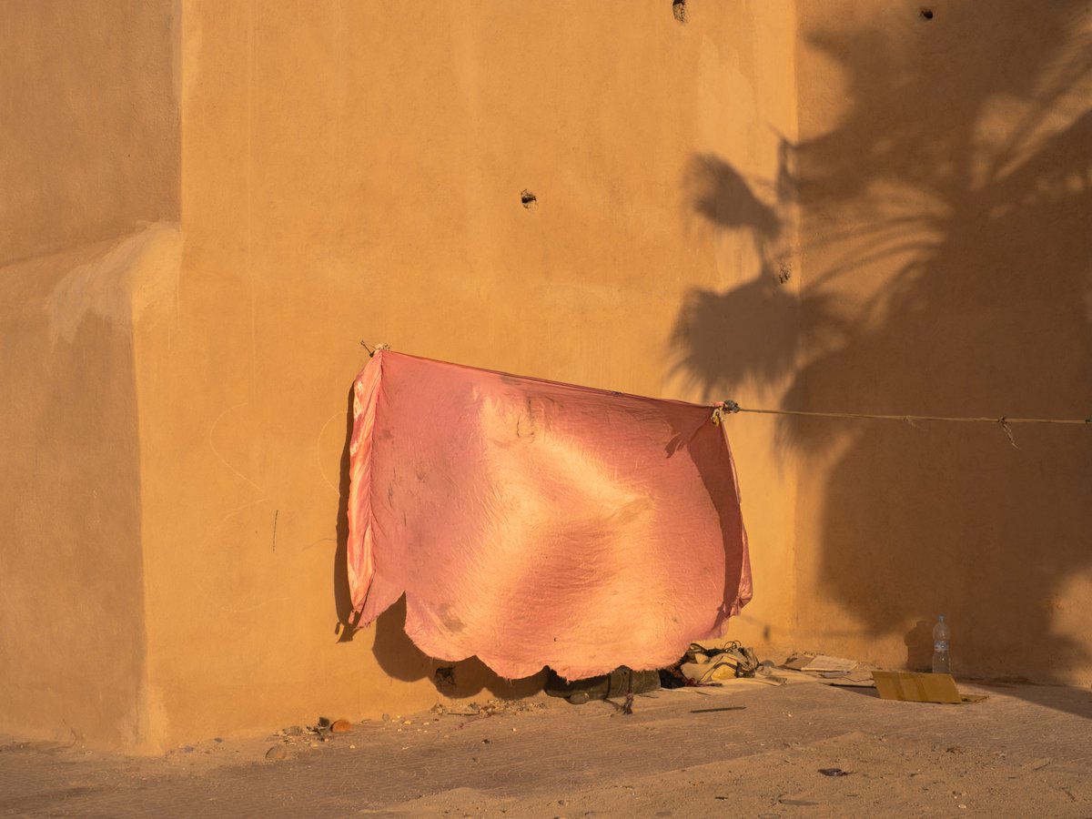 A visual exploration of the Marrakech ancient wall, tracing its transition from a historical barrier designed to ward off potential enemies to a space now inhabited by laboring communities.