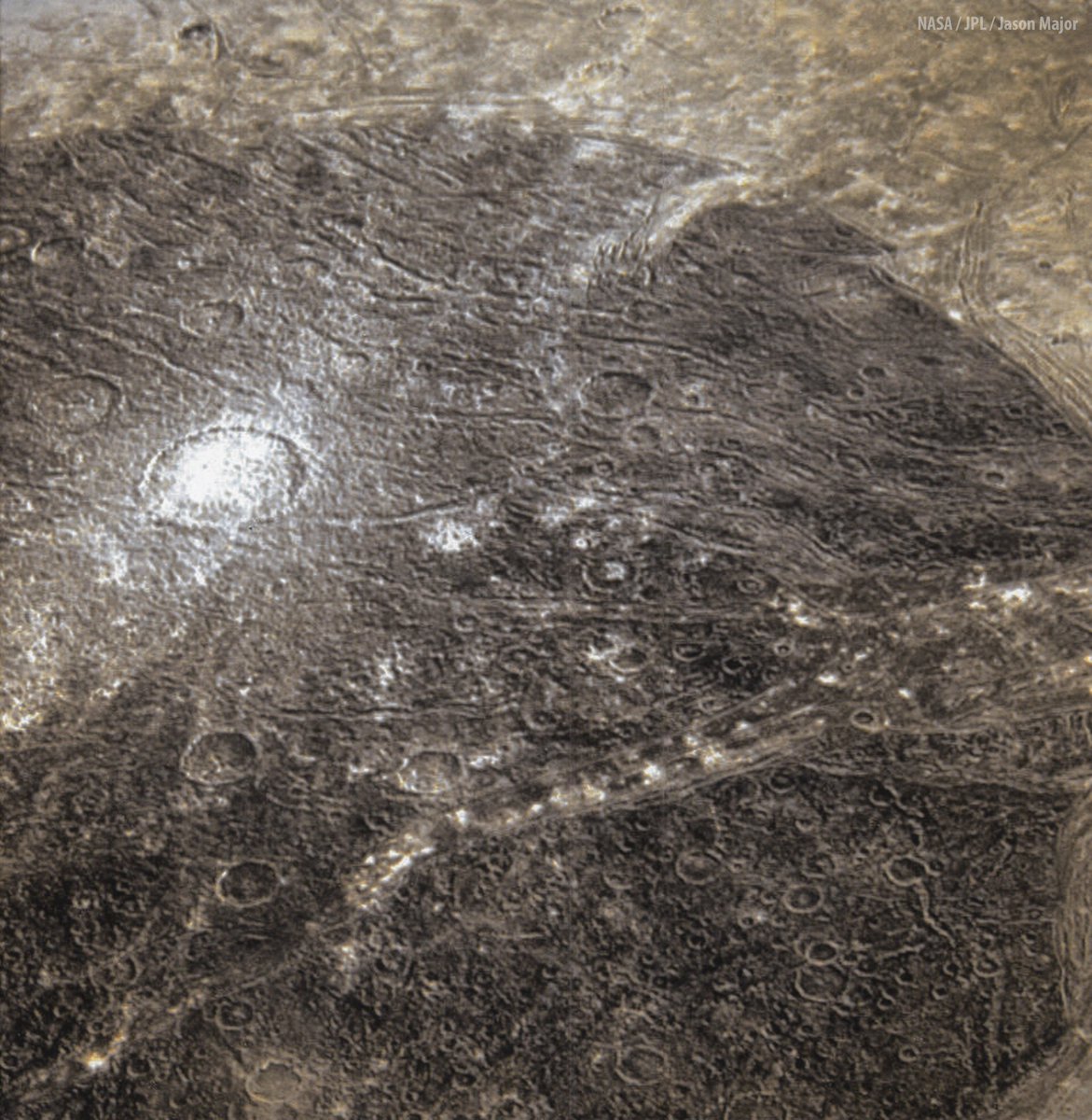 JPMajor's tweet photo. Here's a view of Perrine Regio, an area on Jupiter’s moon Ganymede's north polar region. This is made from Galileo images acquired 23 years ago #OTD on December 27, 2000. The bright spots are areas of reflective ice. https://t.co/XNhZ70CyQZ