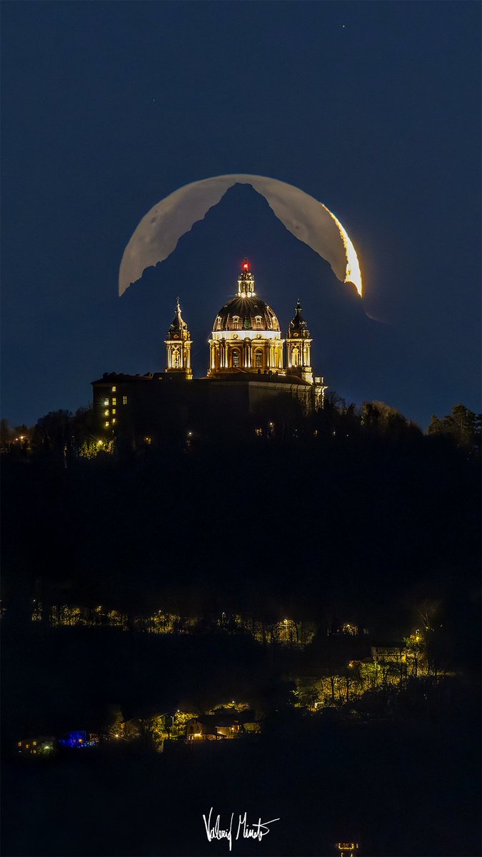 This is an incredible photo. Taken by Valerio Minato (@ValerioMinato), the crescent Moon is setting behind the Monte Viso mountain, which is behind the Basilica di Superga cathedral in Piemonte, Italy. Only a sliver of the Moon is in sunlight; the rest is lit by Earthshine.