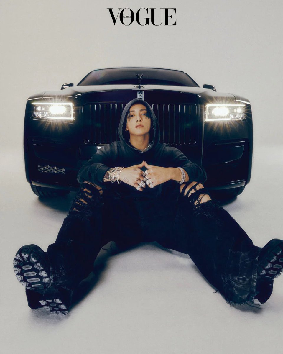 Pays homage to new icons of music by being a model, and giving overall creative direction. Sitting in front of a black sedan, JK visualizes Hiphop musicians of the 21st century. Hooded sweatshirt, Givenchy. Pants, Vetements at Boontheshop. Shoes, Versace. Crystal jewelry, Wooing.