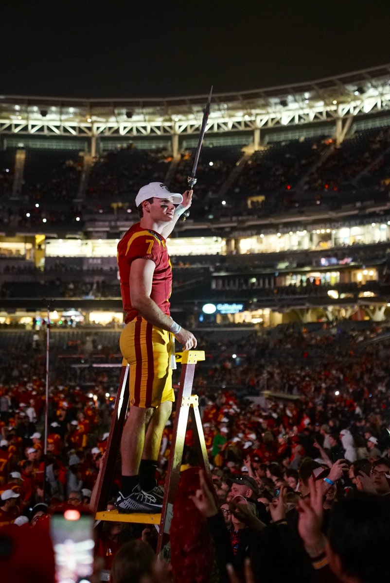 Miller Moss holds the sword in victory after the Holiday Bowl.