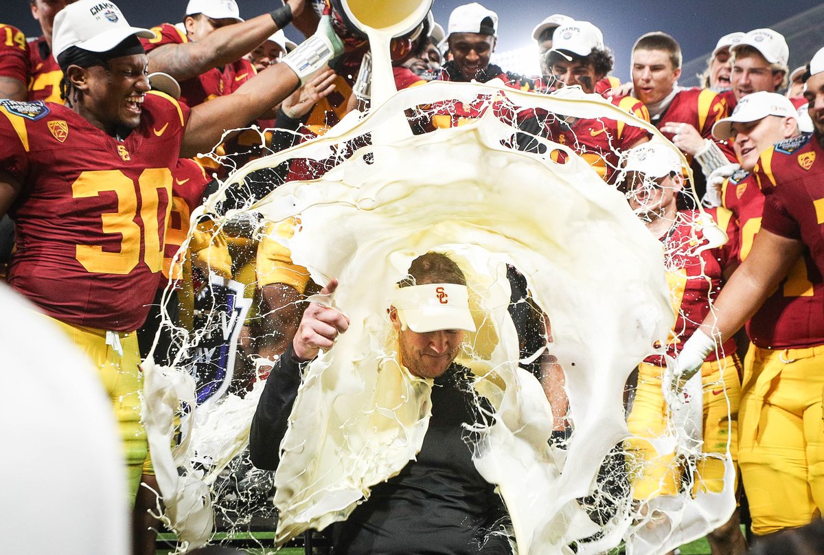MegMcLaughlinDA's tweet photo. USC players pour eggnog onto coach Lincoln Riley after the Trojan's 42-28 win over Louisville during the Holiday Bowl at Petco Park. @sdut https://t.co/bH74OfYwfM