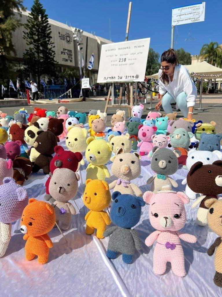 Michael_Wgd's tweet photo. An inspiring initiative, "A Bear for Every Hostage,” spearheaded by our dedicated flight attendant, Hadar Harik. Through this heartwarming project, hundreds of knitters from across the country crafted 240 bears for all the hostages, each awaiting the comforting embrace of a bear upon their return.

While the bears were knit following identical instructions, the diverse colors imbue each one with a unique character, symbolizing the special qualities of the hostages. Harik gathered these bears from various locations and placed them in Kikar Hahatufim at the Israel Museum in Tel Aviv.

This project has filled us and the families of the hostages with great optimism. We remain steadfast in our hopes and wishes for their safe return soon.