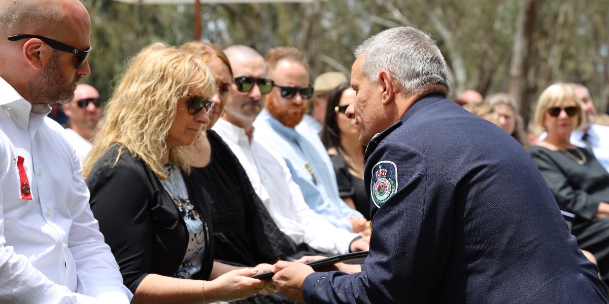 NSWRFS's tweet photo. Today the RFS paid tribute to Group Captain Dale Bowles, who passed away earlier this month while attending a car fire in the Moama area. At his home on the banks of the Murray River, Dale’s family, friends and RFS colleagues gathered for a Service funeral among the gum trees. https://t.co/MqujXHK8ss