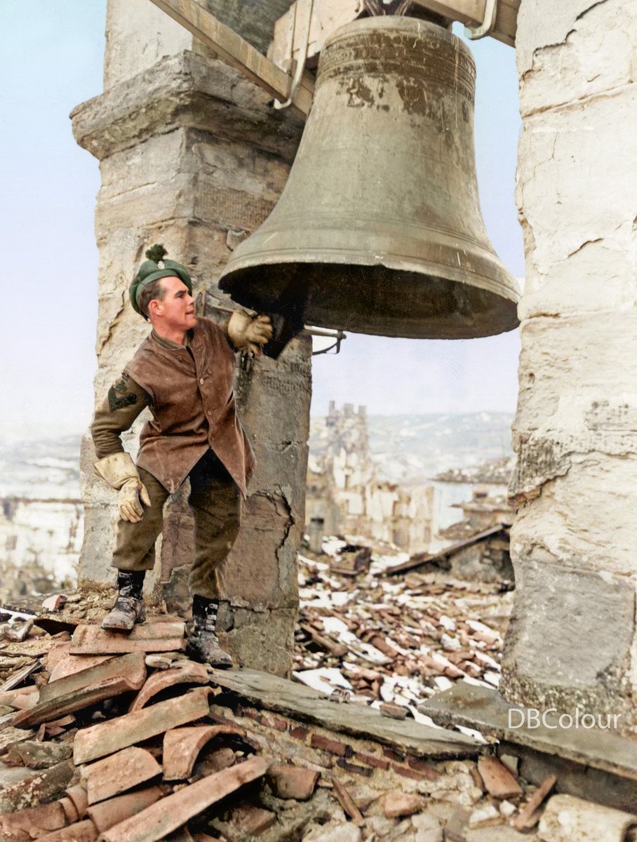 29 December 1944 - Porta Fiorentina in Firenzuola, Province of Florence, Tuscany, Italy Cpl. Wilfred Jennings, Royal Irish Rifles, from Harborne, Birmingham, England, rings in his 4th year away from home.
Photo by Levine. 3131 US Signal Service Co