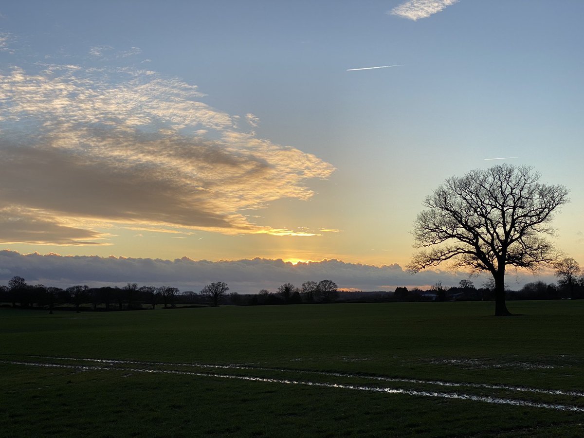 A brief period of not raining gave a sunset over the field.