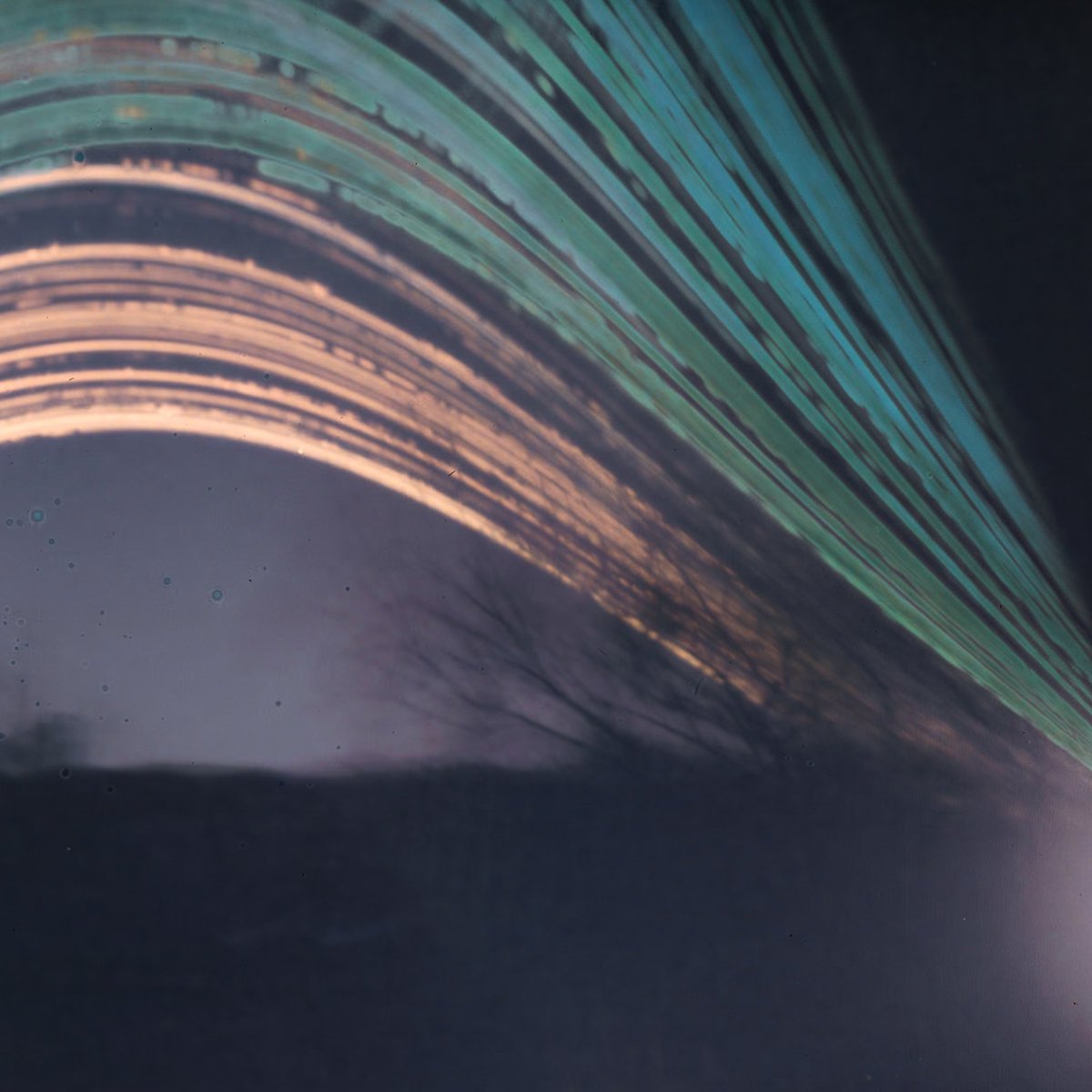 bombsfall's tweet photo. Solargraphy 2023 (1): hillside behind an abandoned church.
11 month exposure, Jan-Dec.
Each line is the path of the sun for that day. You can spot when it was cloudy. The can shifted at some point in the year, creating those smears in the foreground.
#solarcan #solargraphy https://t.co/f95b4aQHXT
