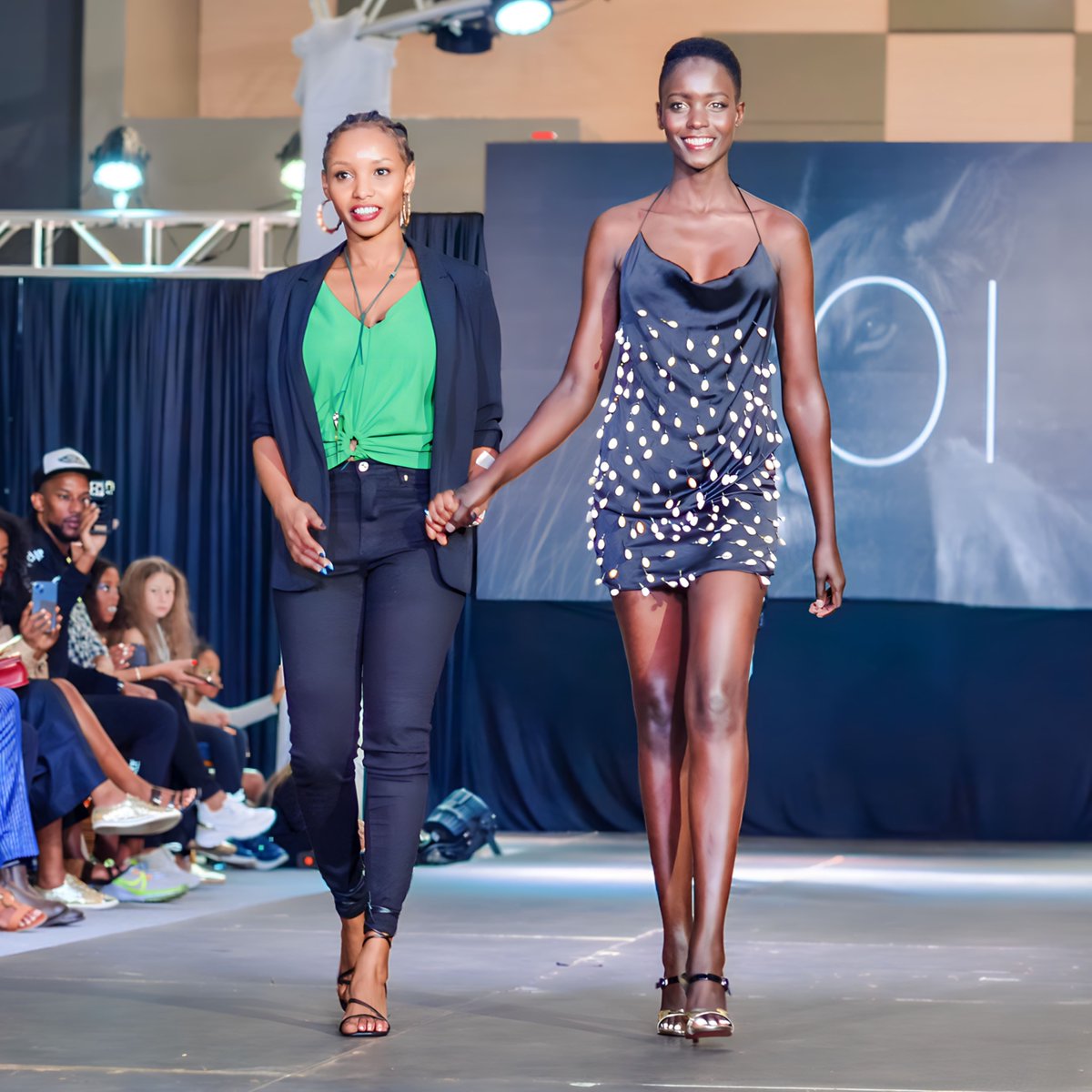 The_NFW's tweet image. Designer Kui takes a bow, wrapping up the show with a captivating black satin mini dress, pearls cascading in style. An exquisite finale capturing the essence of Kenyan fashion. #KuiFashion #DesignerBow #FashionFinale #KenyanStyle