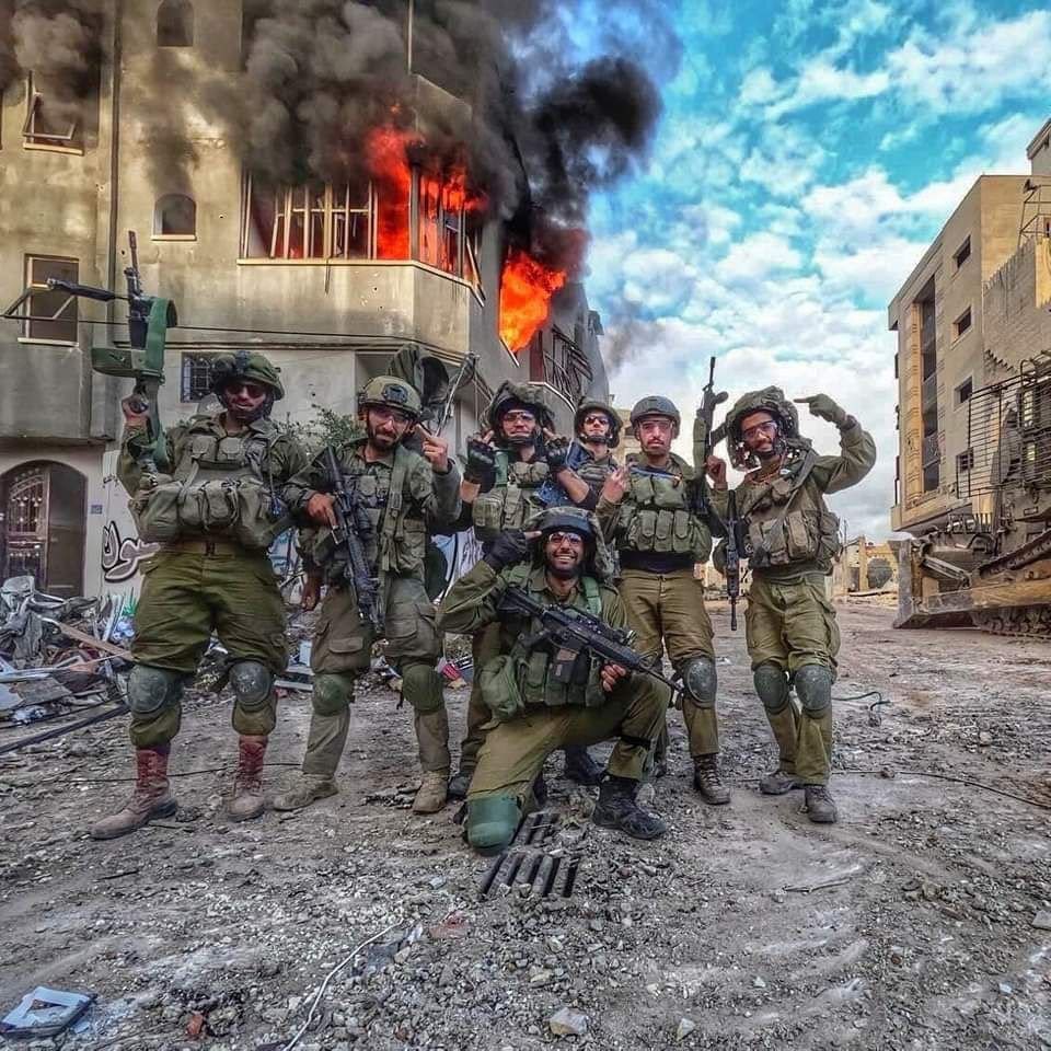 An image that speaks volumes. Lives lost, homes engulfed in flames, displacement, destruction. And there they stand, smiling widely, capturing a photo with the charred house as their backdrop. A haunting reminder of the human cost and disregard for humanity. 

#Gaza_Genicide