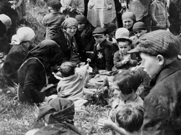 A Jewish child shows her friends a dandelion she found while waiting outside the gas chambers